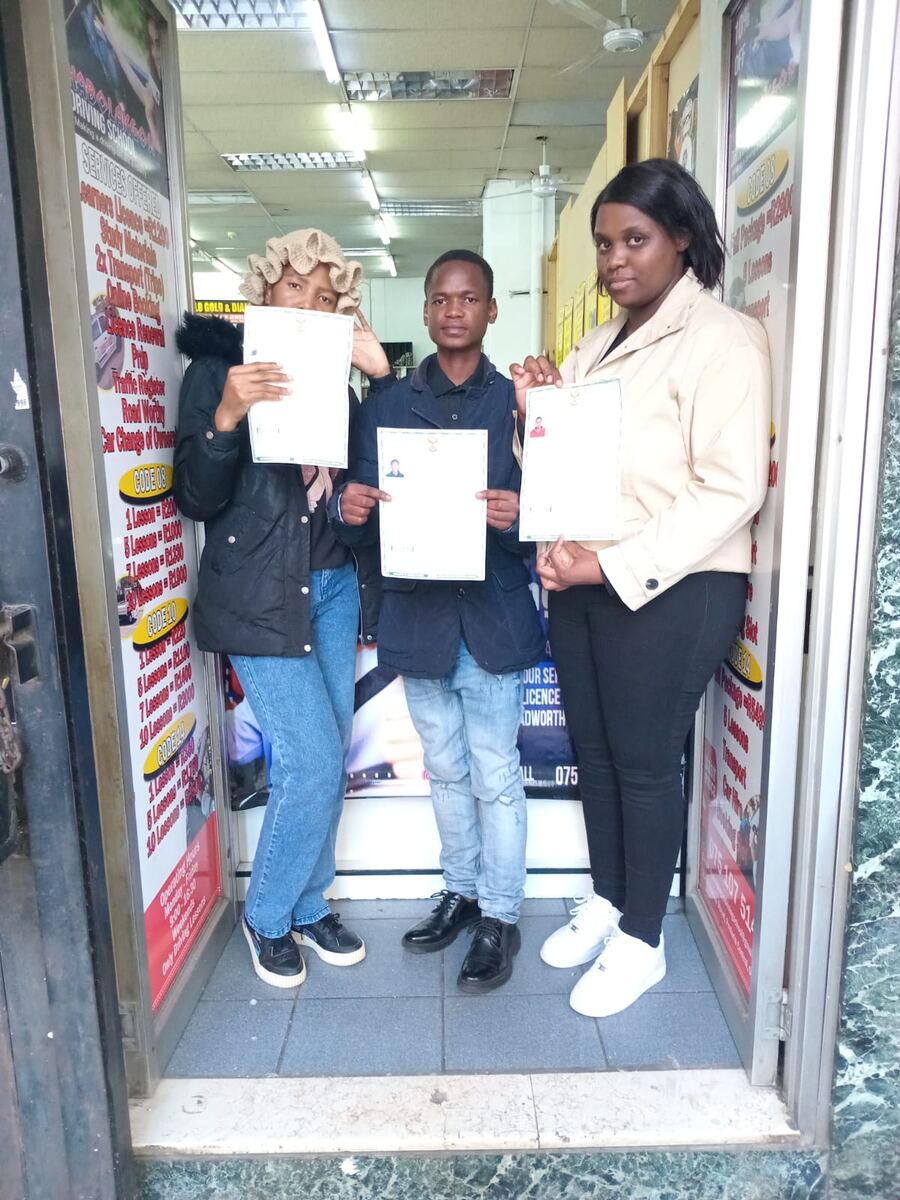 Thabo La Kgosi Driving School students celebrating with their licences