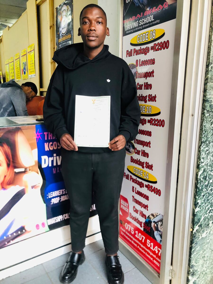 Thabo La Kgosi Driving School student holding his driving licence