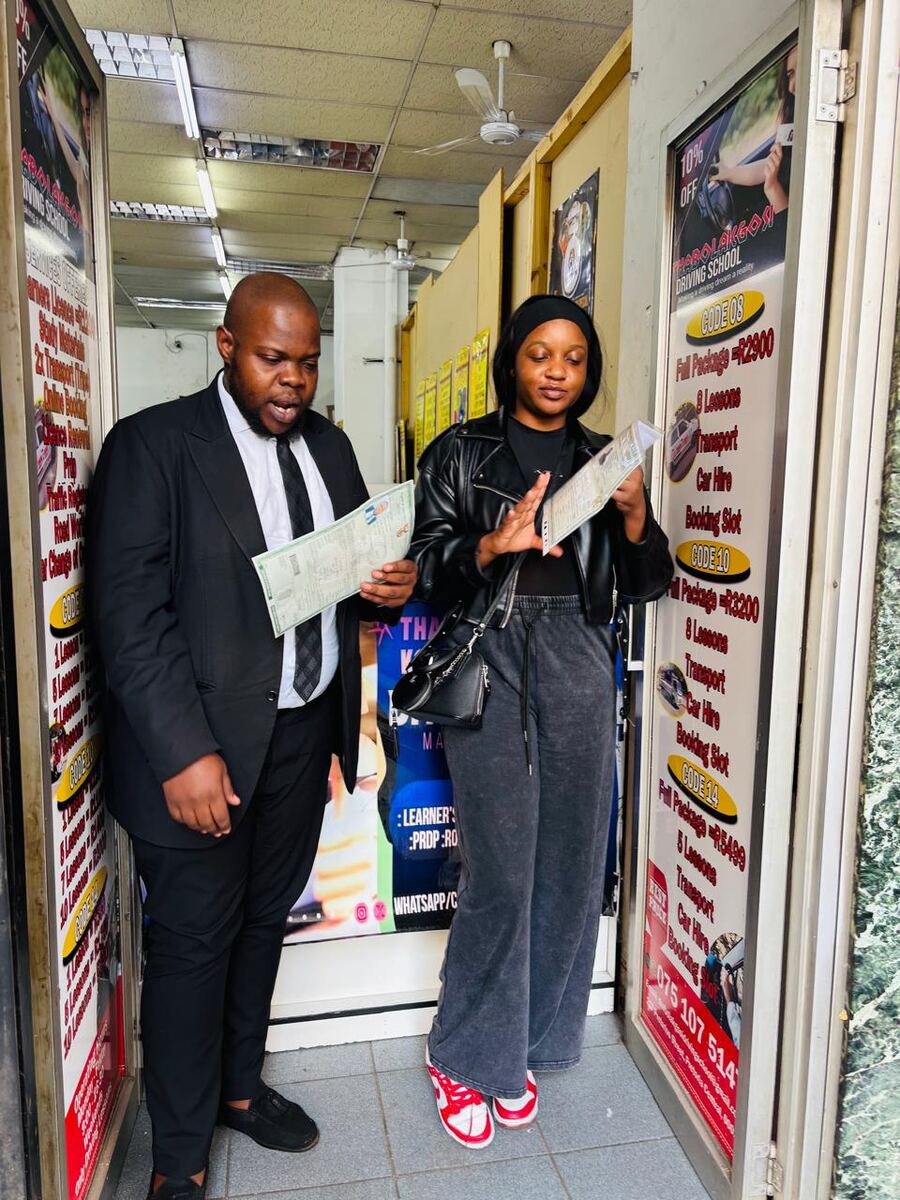 Thabo La Kgosi Driving School students reviewing their licences
