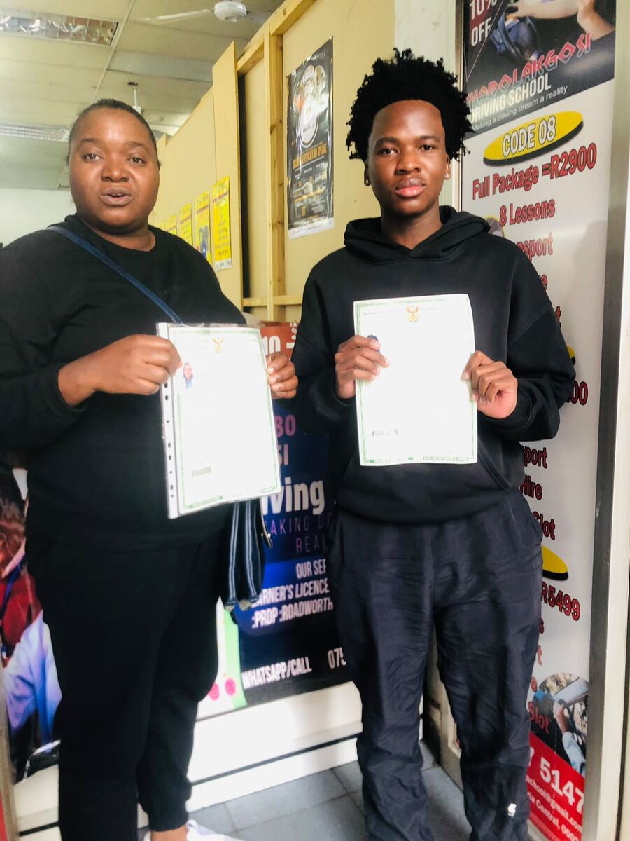 Thabo La Kgosi Driving School students holding their licences