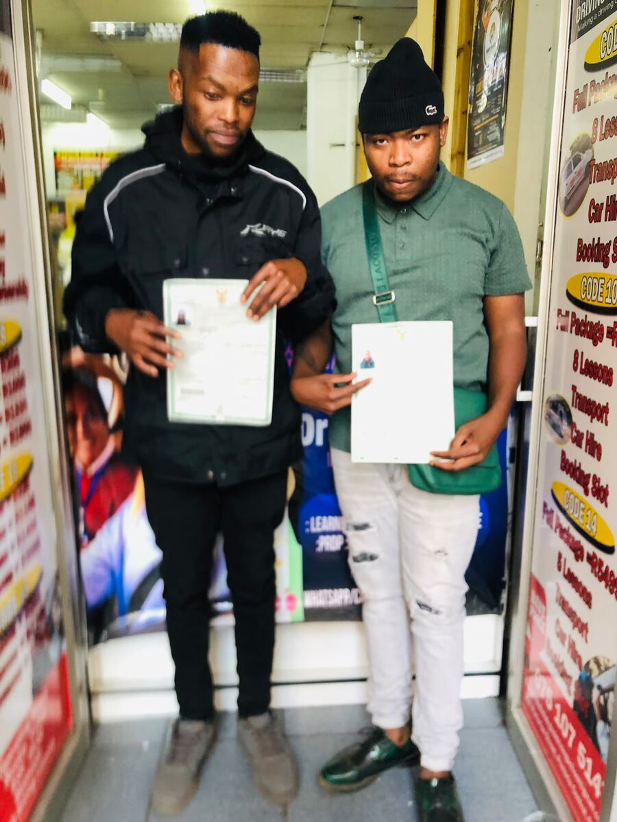 Thabo La Kgosi Driving School students holding their licences